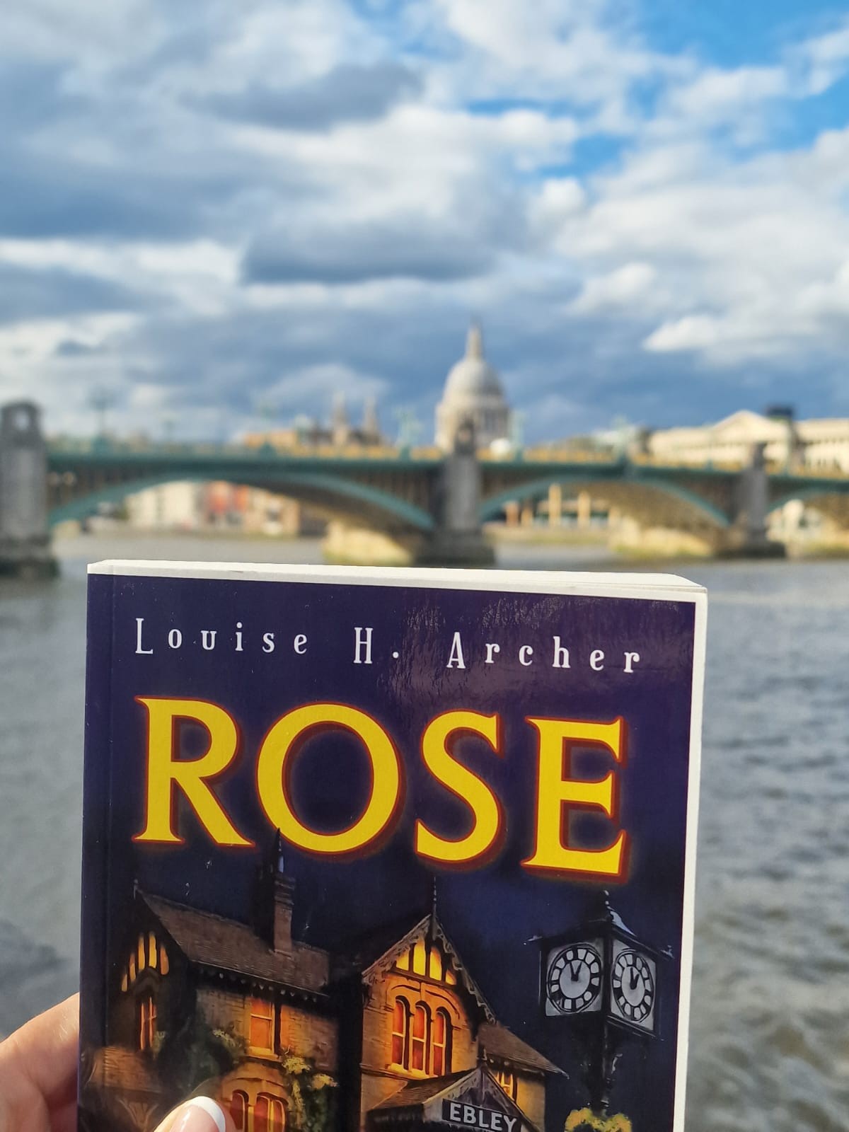 ROSE held up in front of the Thames, Southwark Bridge and St Paul's Cathedral in London